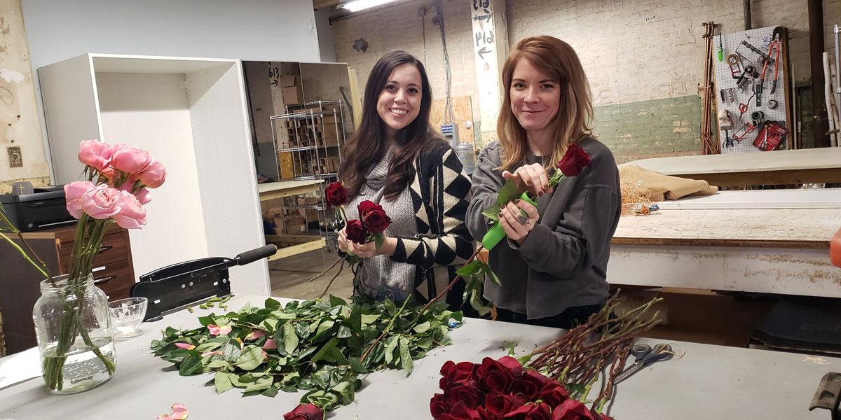 Student Sar Gray-Foreman and mentor Carly Thurman with flowers.